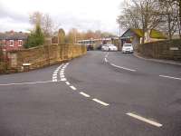 A March 2016 view south east across the infilled Springwood Road overbridge on the former Holmfirth branch. The trackbed is mostly obliterated beyond the A616 Sheffield to Huddersfield Road at Brockholes, with new housing now being built off to the right, in the deep cutting between this bridge and the nearby Heys Road overbridge.<br><br>[David Pesterfield 03/03/2016]