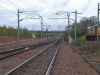 On the far left is the then new turnback siding complete with hump! Also showing (left to right) Down Millerhill and Up Millerhill lines and part of the Up yard with stabled Class 37 loco 37415 in EW&S livery.<br><br>
Whitehill Road bridge features in the middle distance from where railway photographers are wont to take their shots of trains moving to and from Millerhill Yard.<br><br>
Soon to be opened Newcraighall Station is visible in the centre distance beyond the A1 overbridge shown by the white platform edging.<br><br>
A close up shot of the turnout is also available [see image 54551].<br><br>[Charlie Niven 25/04/2002]