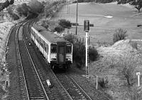 150255 heads for Edinburgh having just exited Winchburgh Tunnel, passing the site of the junction for the Niddry Castle Oil Works branch which diverged to the right. The variant spelling 'Niddrie' is sometimes used for the works.<br><br>[Bill Roberton //1992]