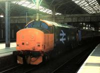 Newly out of the paint shop, a very shiny 37402 has lost its DRS <I>Compass</I> livery in favour of <I>Large Logo</I> blue livery, complete with West Highland Terrier logos. The Class 37, named <I>Stephen Middlemore 23.12.1954 - 8.6.2013</I>, is seen at Preston with the 1004hrs Preston to Barrow-in-Furness on 14th March 2016.  <br><br>[Mark Bartlett 14/03/2016]