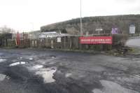 A sleeper palisade fence remains to the north of the former goods yard at Earlston station - one of very few reminders of the railway here. The goods yard was beyond the fence, with the passenger platforms beyond that.<br><br>[Ewan Crawford 06/03/2016]