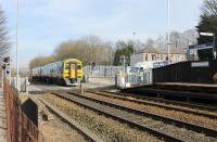 Smithy Bridge level crossing sees 158904 hurry through on a Leeds to Manchester Victoria service on 14th March 2016. The signal box that previously controlled the level crossing closed in 2014 and was only recently demolished. <br><br>[Mark Bartlett 14/03/2016]