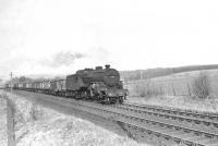 Horwich Mogul 42910 photographed near Failford, South Ayrshire, on 30 March 1959 with a Kirkconnel - Ayr Harbour coal train. [Ref query 5738]  
