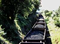 A loaded coal train snakes south through Pontyberem under the Heol Y Pentre road bridge in 1982.<br><br>[Andrew Saunders //1982]