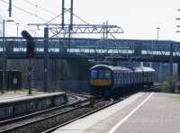 With pointwork and signalling for the closed Widnes line still intact 319377 leaves St Helens Central for Liverpool Lime Street on 11 March 2016. [See Image 41688] for a similar view without the recently erected catenary. <br><br>[Malcolm Chattwood 11/03/2016]