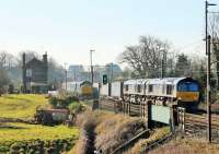 Two of the WCML's more interesting trains pass at Bay Horse on 17th March 2016. DRS 37425 is propelling the 0515hrs from Carlisle towards Preston while DRS 66429 and 66430 are on the Daventry to Mossend <I>Tesco Express</I>, most of which is hidden by the southbound passenger. <br><br>[Mark Bartlett 17/03/2016]