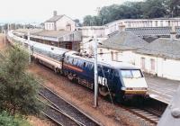 A mid afternoon Glasgow Central – Kings Cross GNER service drifts through platform 2 at Carstairs in August 1997. The train is about to take a sharp left to reach the Edinburgh line at Carstairs East Junction - a manoeuvre requiring care and attention in both directions [see image 7235]. The old station buildings would not remain in place here for much longer. <br><br>[John Furnevel 19/08/1997]