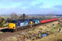 37607 and 37218 work the Georgemas Junction to Mossend engineering train away from Inverness. The wagons are full of old sleepers from Forsinard. In the background, a foggy Culloden.<br><br>[John Gray 17/03/2016]