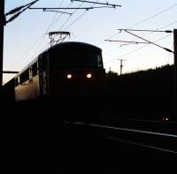 Taking inspiration from the Master Neverers Association photographs of steam  in dying light on the Waverley Route I took this photograph of a southbound freight, in the last glimmer of light, passing through Carstairs.<br><br>[Ewan Crawford //1989]