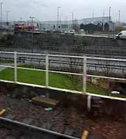 A view of the striking Riverside Transport Museum from a city bound train in heavy rain.<br>In memoriam of Dame Zaha Hadid, architect.<br><br>[John Yellowlees 04/04/2016]