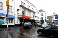 The road approach to Richmond station on a wet Friday afternoon in July 2005. Note the Art Deco, Portland Stone frontage, with its distinctive square clock. The whole area between the station entrance and the bus stop on the far right has since been paved over and pedestrianised. <br><br>[John Furnevel 22/07/2005]