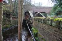 Standing on the bank of the North Esk at Auchendinny looking east in March 2016, with the surviving station platform beyond the wall on the right [see image 5609]. Here the river first runs below the old railway bridge (which carried the line into Auchendinny Tunnel) then below the B7029 road bridge, which spanned both the raiway and the river.<br><br>[John Furnevel 28/03/2016]