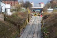 View up the Incline from Pinkston Road. Rail mounted cement mixers and Road/Rail Vehicles can be seen parked at the Keppochhill Drive/Fountainwells access point. Above them can be seen the blue painted Fountainwells overbridge which is scheduled for demolition soon.<br>
<br><br>[Colin McDonald 15/04/2016]