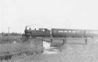 Crossing the Water of Philorth on the approach to Philorth Bridge Halt in the summer of 1951. Ex-GER 2-4-0T 67164 is at the head of a Fraserburgh - St Combs train.<br><br>[G H Robin collection by courtesy of the Mitchell Library, Glasgow /07/1951]