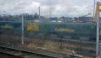 A pair of 86s (86610/4) seen from a passing train at the Coatbridge Freightliner Terminal. Somewhat dirty window, unfortunately.<br><br>[John Yellowlees 13/04/2016]