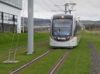 Tram 277 approaches Edinburgh Park Central with a westbound service.  In the background is the bridge over the E&G at Edinburgh Park.<br><br>[Bill Roberton 06/04/2016]