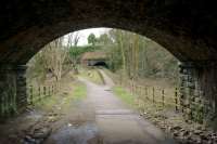 Standing under Hyde Bank Road bridge in New Mills in April 2016, looking west along the formation of the former Hayfield branch, towards the tunnel that lead to New Mills Central station. Much of the former branch line has been converted into the Sett Valley Trail although at the New Mills end it does not include the tunnel and some 'civils' have been carried out in front of it to provide access to the town.<br><br>[John McIntyre 09/04/2016]