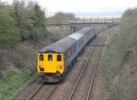 DBSO 9707 brings up the rear of a Barrow bound service headed by 37409 at Warton on 18th April 2016. The train is just passing under the old Carnforth Ironworks Tramway bridge [see image 29936], above which can be seen Grange-over-Sands and Morecambe Bay at low tide.  <br><br>[Mark Bartlett 18/04/2016]