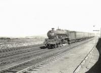 An Ayr bound train photographed at speed near Prestwick on Saturday 28 March 1959. Locomotive in charge is Jubilee 45711 <I>Courageous</I>.  <br><br>[G H Robin collection by courtesy of the Mitchell Library, Glasgow 28/03/1959]