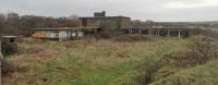 Margam yard office block is still standing some 36 years after the yard hump closed (1980). The majority of the remaining yard closed in 1987 on opening of the rebuilt Knuckle Yard. The office block is between the reception sidings and the yard hump. This view is looking towards Pyle with the main line behind the offices.<br><br>[Alastair McLellan 04/01/2012]