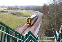 The 1024 Edinburgh – Tweedbank heading south alongside the Gore Glen on 10 April 2016, with the houses of Gorebridge just coming into view in the background. Over to the left stood the Gore Pit and the exchange sidings, fed by the mineral line running south from Engine Road.  [See image 54843] The connection between the Arniston colliery line and the main line was further east towards Gorebridge station.<br><br>[John Furnevel 10/04/2016]