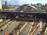  View over the Queen Street works as sleepers are being laid for the realigned platform 4 and 5 roads. The crane on Cathedral Street Bridge is lifting down building materials for the reconstruction of the north end of platforms 1 and 2. Only platform 7 where the ballast train is stabled now has the track dating from before the start of the station works. <br><br>[Colin McDonald 28/04/2016]