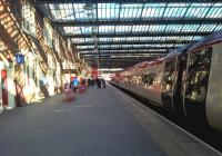 The 18.12 to Euston pauses at Stoke on the 16th of April 2016. The setting sun produces strong shadows, giving the station a very different appearance from my previous late night shot [see image 35163]. Notice the traditional blue lamp outside the BTP offices on the left.<br><br>[Ken Strachan 16/04/2016]