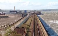 A wild and windswept Stranraer Harbour on the afternoon of 25 April 2016. Just visible at the platform in the distance is the 1659 departure for Glasgow Central via Kilmarnock.<br><br>[Andy Furnevel 25/04/2016]