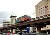 Now that's what I call a Skytrain [see image 54850] The entire track is on a concrete viaduct. The cable-driven train between Birmingham International station (left) and Airport (right) may be noisy, but it's free. Taken from a 'long stay' (one hour or more) car park.<br><br>[Ken Strachan 22/04/2016]