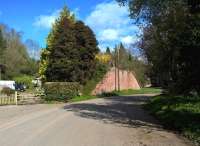 A distinctly scenic spot to the West of Tenbury Wells on the way to Woofferton [see image 21588]. This is taken from the former alignment of the A456, now a layby, while the course of the modern road runs straight past the trees on the right. An abutment of the former railway bridge still stands, some 50 years after closure. The shelf visible among the trees to the left is the course of the former Tenbury Canal, much of which was built over by the railway. <br><br>[Ken Strachan 17/04/2016]