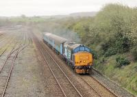 37409 accelerates the 1004 Preston to Barrow away from Carnforth F&M Junction and past the engineers sidings as it heads towards the bridge at Warton and the next stop at Silverdale. The link from F&M Junction to Carnforth East (straight ahead in the distance on this image) closed in 1998 and the two signal boxes were demolished. Occasional trains working through from the Barrow line to Settle Junction now have to run through the station and reverse in the loops alongside the WCML.<br><br>[Mark Bartlett 18/04/2016]