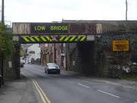 View south west towards Barnsley town centre, showing the rusty low headroom rail overbridge across Summer Lane on the line to Penistone. Summer Lane station was located some 100m to the right.<br><br>[David Pesterfield 28/04/2016]