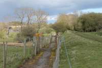 View north alongside the Border Counties Railway track bed, just south of Humshaugh station. This view looks north with the Chollerford bridge over the North Tyne visible on the left. The footpath leads to the Chesters Bridge Abutment, a nearby Hadrian's Wall antiquity. [Ref query 51674] <br><br>[Mark Bartlett 30/04/2016]