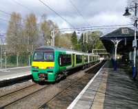 Familiar stock in unfamiliar livery can look quite striking: 320 411 stabled at Milngavie on 30/04/2016.<br><br>[David Panton 30/04/2016]