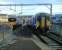 A Motherwell (left) service pulls into Anniesland station simultaneously with a terminating train from Queen Street on 05/03/2016.<br><br>[David Panton 05/03/2016]