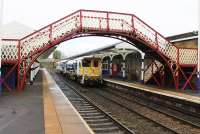 Movement of plant before and after weekend engineering possessions can lead to some interesting routings. DR77001, rumbling through a damp Hexham station on the 2016 May Day bank holiday, was travelling from Lockerbie to Morpeth.<br><br>[Mark Bartlett 02/05/2016]