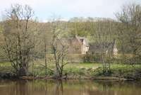 Humshaugh (pronounced Humshoff I'm assured) station closed in 1956 with the withdrawal of passenger services between Hexham and Riccarton Junction and is now a private residence. The old station is seen here, sixty years after the last passenger train left, from across the North Tyne river at Chollerford in April 2016. [See image 43325] <br><br>[Mark Bartlett 30/04/2016]