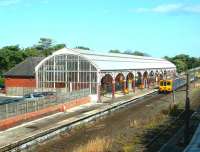 View over Monkseaton station looking south east from Front Street road bridge on 10 July 2004. A Tyne & Wear Metro train is at platform 2 with a service for St James via the coast.<br><br>[John Furnevel 10/07/2004]