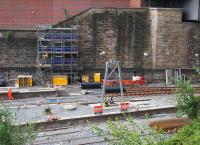 First signs of signalling equipment are now appearing at Queen Street High level - in the centre of the photograph an A-frame support has been erected at the end of realigned platforms 3 and 4. Above and left, taking shape behind the scaffolding a similar structure is attached to the west retaining wall and another is being erected on the east retaining wall out of shot to the bottom right. These will support a signalling gantry spanning the width of the station. (Thanks to Network Rail Scotland for the correction to the caption).<br>
 <br><br>[Colin McDonald 21/05/2016]