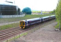 ScotRail 158710 leads the 4-car 0945 Tweedbank - Edinburgh Waverley on 15 May 2016. The train is passing the Biogen anaerobic digestion facility at Millerhill between the Shawfair and Newcraighall stops.<br><br>[John Furnevel 15/05/2016]