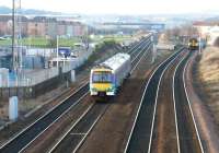 A Glasgow - Edinburgh shuttle runs east at Saughton Junction in December 2002. In the right background a train is approaching on the Forth Bridge route.<br><br>[John Furnevel 11/12/2002]