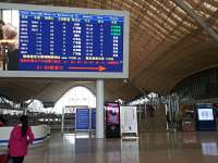 Wuhan station showing the futuristic airport-like departure hall. The departure board helpfully has column headings in English, although train details may present some difficulties to English only speakers.<br><br>[Mark Poustie 12/12/2014]