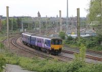 Northern Sprinter 150110 swings west at Fylde Junction  with a Hazel Grove to Blackpool North stopping service on 19th May 2016. The Lancaster lines can be seen behind the train. <br><br>[Mark Bartlett 19/05/2016]