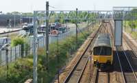 A Northern Class 150 DMU heads south on the Up Slow between Farington Jct and Leyland on 14 May 2016. On the left is the former Leyland Trucks site and the sidings which are presently the subject of a planning application for a temporary servicing and refuelling point while electrification work prevents the use of the existing facility at Blackpool North.<br><br>[John McIntyre 14/05/2016]