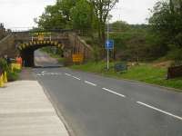 The low and narrow rail overbridge across Haigh Lane, near the former Haigh Station, between Horbury Junction and Barnsley is being prepared for replacement in a 52 hour possession over the Bank Holiday weekend. The land to right has been cleared, and scaffold erected along the far side of the bridge to carry rerouted S&T cabling during the works. A large area on the left has been taken over by Balfour Beatty as a works site, and a pad for construction of the new deck structure. The deck should be moved into final position atop a multi wheel remote control heavy lift unit. <br><br>[David Pesterfield 19/05/2016]