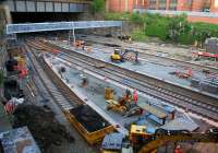 The signal gantry which has been erected at the north end of the recently extended platforms is seen a couple of days after the span was fitted. Meanwhile what could easily pass for a coal waggon (it isn't) collects spoil from excavation work alongside the platform 1 road under the Cathedral Street bridge. <br><br>[Colin McDonald 31/05/2016]