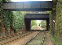  A view of the two overbridges west of the former Newington Station. The bridge closer to the camera is the mysterious OB15 which is listed as an aqueduct. Is there any water still flowing across it? The further away bridge is the rather less mysterious OB16 Mayfield Road. The ivy fairly cascades down the face of the retaining wall between them. Also showing are octagonal white 'SAND' signs beyond the bridges, one on each Cess.<br><br>[Charlie Niven 25/04/2002]