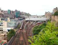 View from Regent Road over the east end of Waverley on Saturday morning 4 June 2016. From the left: running into platform 8 from the Calton Tunnel is the Virgin Trains 0610 (SO) ex-Doncaster, class 90 and 67 locomotives are stabled in the sleeper bays, the ScotRail 0943 to North Berwick awaits departure at platform 3 and the VTEC 0930 to London Kings Cross is boarding at platform 2. Bottom left, on the site of the former New Street bus depot, are signs of the £750m 'New Waverley' development currently underway. [See image 9503] <br><br>[Andy Furnevel 04/06/2016]