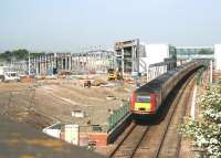 View north over Edinburgh Gateway from alongside the A8 on 7 June 2016. The newly installed link bridge is on the left, connecting with the tram route on the lower level. About to run through the upper level platforms is the Virgin Trains 0710 Leeds - Aberdeen HST. <br><br>[John Furnevel 07/06/2016]