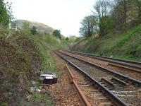 An example of a CWR expansion joint (Adjustment Switch). The short pieces of rail hold the special timbers in position whilst the slip joint allows for expansion and contraction of the rails. The sleepers on the Up line were concrete.<br>
Looking east from the position of a former signal post now occupied by pieces of timber in the Cess. Location is between what is now Relugas Place on the left and East Champanyie on the right. Hard to believe that there had been an extensive system of sidings on the Up side. Despite the obvious signs of Spring it seems that there was still a dusting of snow on the side of Arthurs Seat in the background.<br><br>[Charlie Niven 25/04/2002]